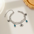 Double-layer silver Evil Eye bracelet with blue teardrop pendant and crystal accents - Silver