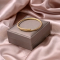 Detail of gold cable twist open cuff bracelet with spherical end caps on silk backdrop - Cable Style (S277-1)