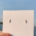 Elegant gold metal bar stud earrings with small clear stones on a display card - 925 Silver Needle / Gold Bar