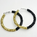 Detail view of large hoop earrings in gold and black glitter finishes with sequins - Black and Gold