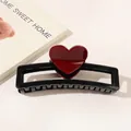 Detail of a black rectangular hair claw clip with a glossy red heart on white background - Heart Hollow Rectangle / Black