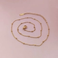 Close-up of gold stainless steel beaded chain necklace with lobster clasp and adjustable link - Gold Cross Bead Chain