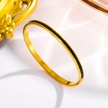 Macro shot of 18k gold plated stainless steel bangle with inlaid black square gemstones - Gold + Black Zirconia