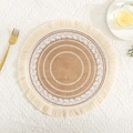 Close-up of a jute placemat with white circular patterns and beige tassels on table - White Tassel Pattern 3