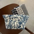 Macro shot of canvas cosmetic bags with floral patterns and durable metal zippers - Tie-dye Flower Branch