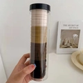 Minimalist elastic hair ties set in earth tones stored in a clear plastic barrel container - 20 Pieces Canned / Brown