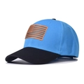 Detail view of cotton baseball cap with American flag leather patch and blue crown - Adjustable / Sky Blue + Black