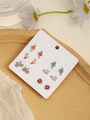 Close-up of 6 pairs of enamel earrings with animal and ballet motifs on a weekly card - Colored Ballet Bicycle Sports (FX885-10)