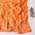 Soft muslin cotton swaddle blanket featuring a yellow daisy floral pattern on plush background - Orange White Daisy