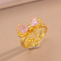 Golden bow ring featuring pink heart-shaped crystals and shimmering pavé stone accents - Gold Pink Bowknot Ring (8844)