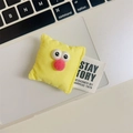 Detail of yellow plush bread toy phone stand on a laptop with cute cartoon eyes - Pillow Face / Yellow