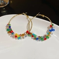 Detail of gold hoop earrings with vibrant colorful crystals on a white ceramic plate - Gold Hoop Multi-color Beads (Large)