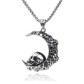 Macro detail of crescent moon pendant with skull design on silver box chain necklace - Moon Skull