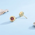 Minimalist gold titanium stud earrings featuring Roman numerals and a red crystal center - Red