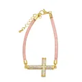 Detailed shot of a gold-plated cross bracelet with white zircons and pink mesh cord - E-Pink Metal Mesh Gold Cross
