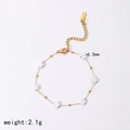 Detailed macro view of 2.1g gold steel bracelet with six 6.5mm white star charms - White Star Bracelet (TB3403)