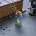 Ghost necklace featuring a white ghost and green moss inside a glass bottle pendant - Moss Style Necklace
