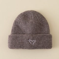 Detailed close-up of dark brown knit beanie with white hand-drawn heart embroidery - Hat / Brown