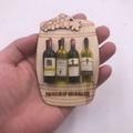 3D wooden wine barrel fridge magnet featuring mini bottles and carved grapes from Georgia - Wine Bucket 4 Bottles