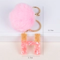 Pink fur pompom keychain with gold foil resin letter H and metallic lobster clasp - Letter H