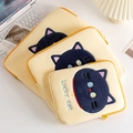 Three sizes of yellow plush laptop sleeves with lucky cat embroidery on a desk - 11" / Yellow Cat Head