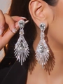 Elegant silver tassel earrings with sparkling rhinestones and pear-cut crystal accents - Pear-Shaped Main Stone Tassel / Silver