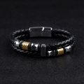 Close-up of black leather braided men's bracelet with silver and gold magnetic clasp - Steel and Gold