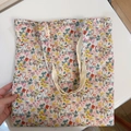 Detail of floral canvas tote bag with dense red and yellow patterns and sturdy shoulder straps - T-38 Beige Background Floral