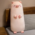 Pink long plush pig pillow with cute facial embroidery on a comfortable bed - Blink Eyes / 70cm