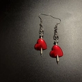 Detailed view of rock music festival gothic earrings with red heart and silver bat skull - Heart with Arrow