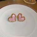 Detail of pink heart-shaped earrings with gold textured edges on a ceramic plate - Pink Enamel Gold Edge Heart Studs