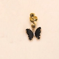 Close-up of golden braid ring with black crystal butterfly pendant and small diamond accents - Black Zirconia Gold Plated