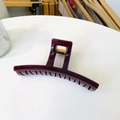 Detail of a large deep purple hair claw clip with a durable golden metal spring - Cherry Red