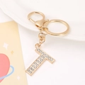 Detail of gold-plated letter T keychain featuring shimmering rhinestones and clasp - Letter T