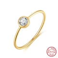 Detailed macro view of S925 sterling silver ring with gold plating and round cubic zirconia - US 5 / 14K Gold