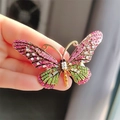 Vintage butterfly brooch with pink and green crystals held in hand for scale - Enamel Rhinestone Rose Red Butterfly