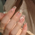 Close-up of French blush press-on nails with gold stars, moon, and rhinestone accents - By1023#crescent Moon And Stars / Tool Kit Style