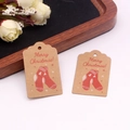 Detailed view of Kraft paper gift tags with Merry Christmas text and red stocking designs - Style 8/Christmas Stocking / 3*5cm [100Pcs]