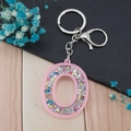 Pink acrylic letter O keychain with colorful star sequins and silver metal clasp - Letter O