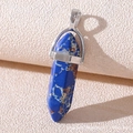 Macro shot of blue hexagonal column stone pendant with silver clasp on beige texture - Dark Blue Veined Stone