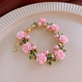 Macro detail of a pink rose pearl bracelet with gold leaves and sparkling crystals - Bracelet-Pink