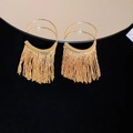Close-up of gold tassel earrings with polished semi-circles reflecting on a mirror - 11# Gold Hook