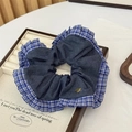 Detailed shot of a blue denim hair scrunchie with plaid ruffle edge and metal button - Dark Blue Ruffle (Approx. 12cm Dia)