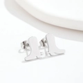 Macro shot of silver cowboy boot stud earrings in polished stainless steel - Boots Steel
