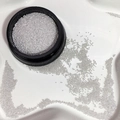 Silver micro metal beads for nail art stored in a black jar and scattered on a tray - Silver Steel Ball 0.6mm