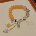 Ethnic beaded bracelet with 12mm natural rutilated quartz and silver Buddha charms - Imitation Amber Natural Hair Crystal Buddha Bracelet