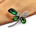 Macro shot of silver dragonfly brooch featuring green gems and pavé crystal wings - Style 01 Crystal Dragonfly