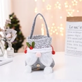 Close-up of Christmas gnome gift bag featuring soft plush beard and wooden button detail - Grey Braid Style / Gray