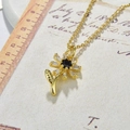 Macro detail of sunflower pendant with black center and clear crystal petals - Sunflower Necklace / Black