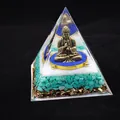 Macro view of crystal healing pyramid with bronze Buddha and layered crushed stones - 10cm / Shakyamuni Buddha